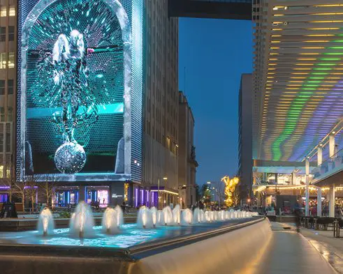 A fountain in the middle of a city street.